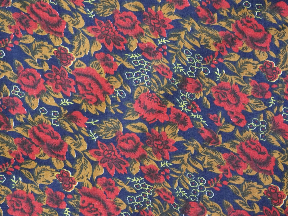 An antique Uzbek Nim Suzani textile featuring hand-embroidered floral motifs and hooked borders in purple, yellow, and blue silk threads on a tan cotton ground. View X