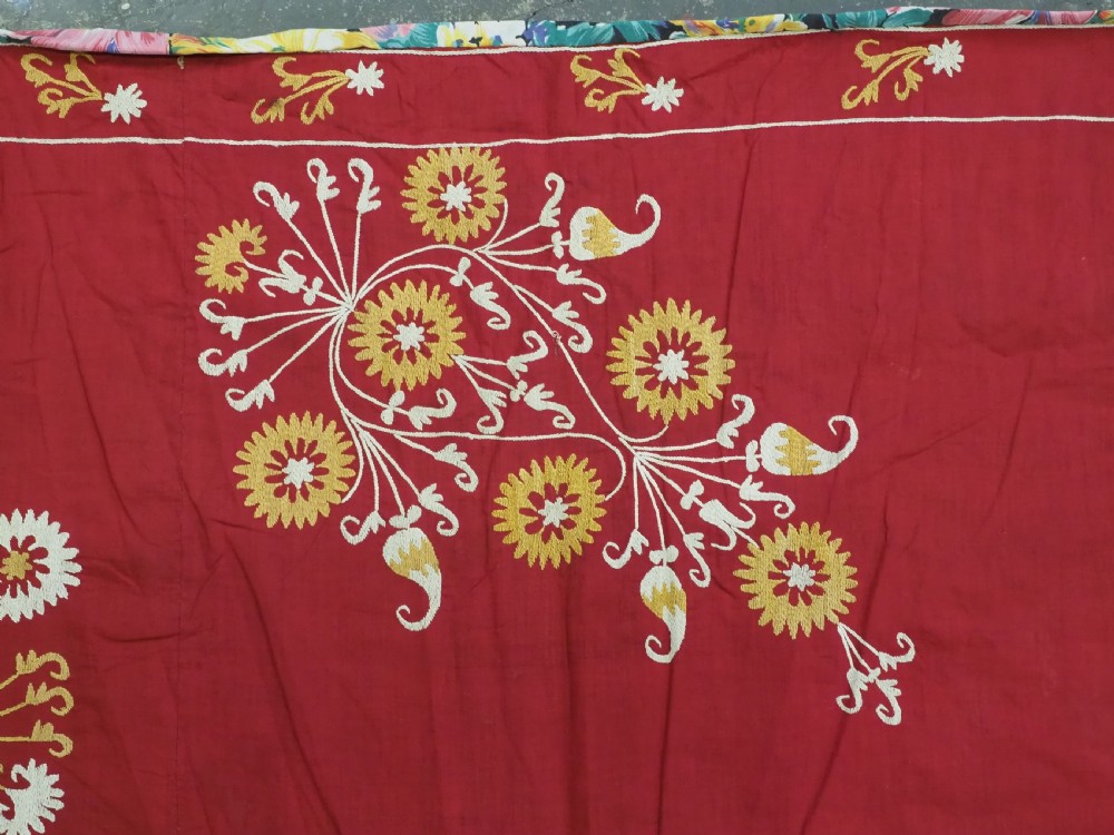 A rectangular red adras silk and cotton textile featuring yellow and white silk thread embroidery with a central circular floral medallion, surrounding floral sprays, and a matching decorative border. View VII