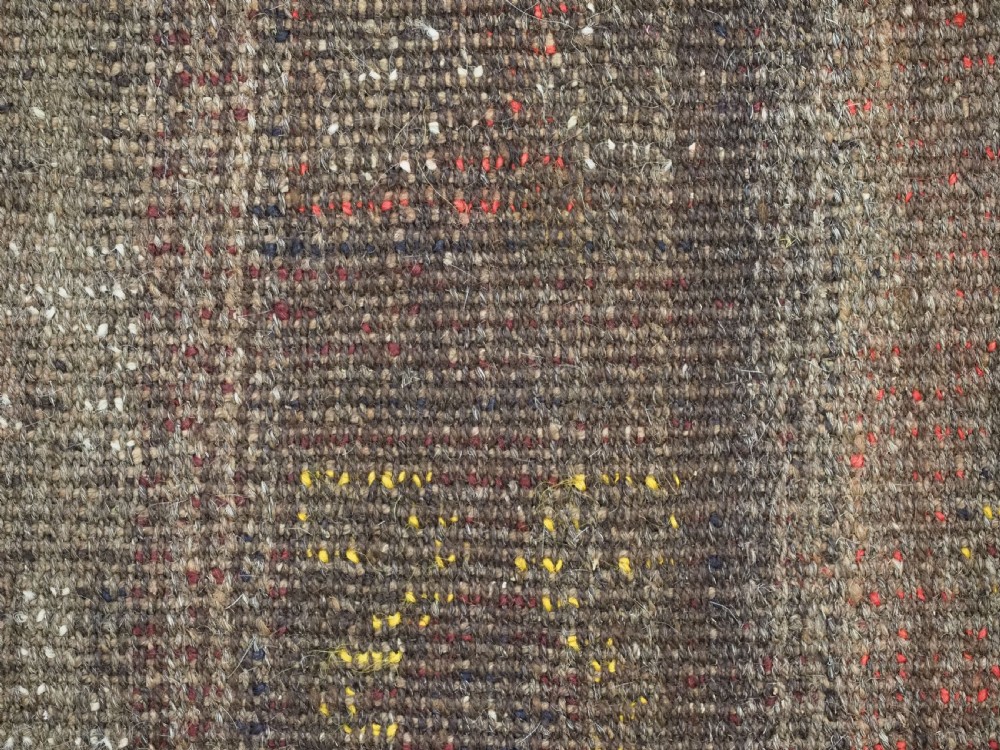 An antique handwoven Uzbek Julkyrs rug with geometric star motifs constructed from four vertical wool strips stitched together in tones of brown, red, and yellow. View XV