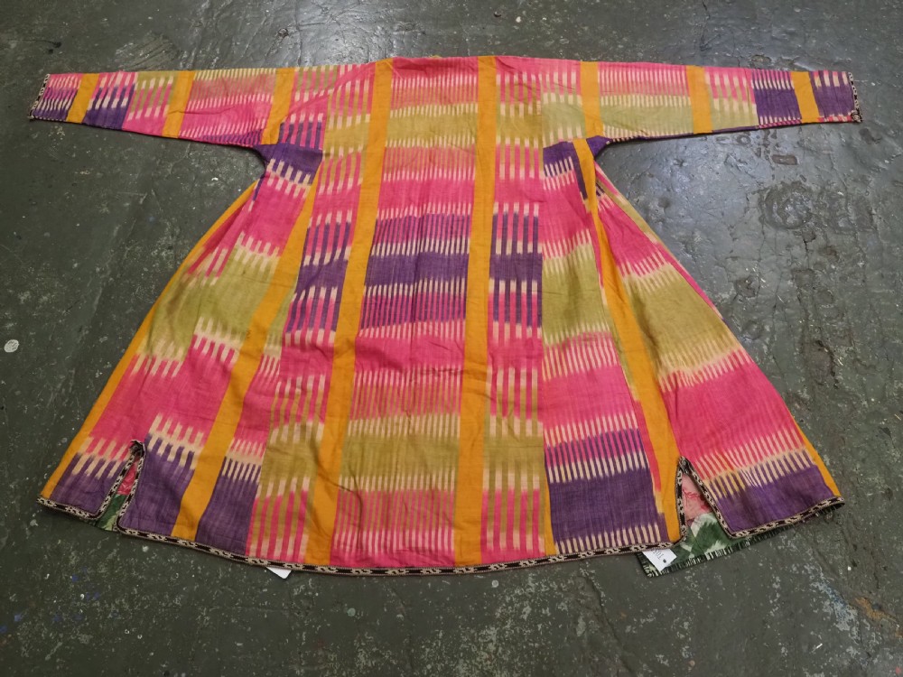 A late 19th-century Uzbek silk ikat khalat robe displaying pink, yellow, green, and purple vertical patterns. View II