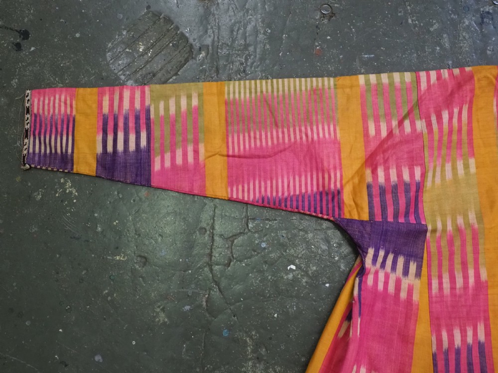 A late 19th-century Uzbek silk ikat khalat robe displaying pink, yellow, green, and purple vertical patterns. View III