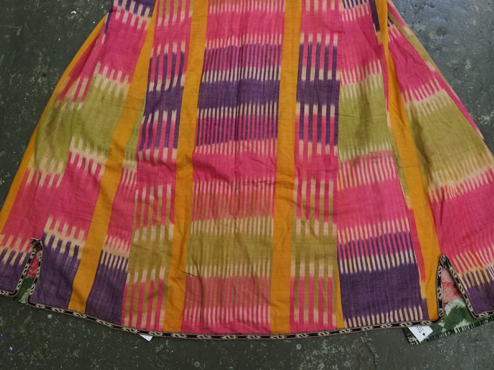 A late 19th-century Uzbek silk ikat khalat robe displaying pink, yellow, green, and purple vertical patterns. View VI