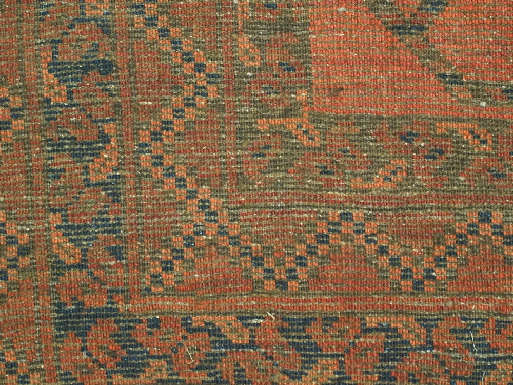 An antique hand-knotted wool carpet featuring repeating octagonal gul motifs on a terracotta background framed by geometric borders. View XIII