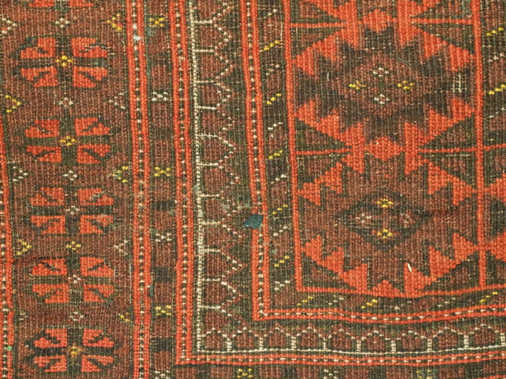 An antique Afghan Kizil Ayak Turkmen wool carpet featuring repeating octagonal gul motifs on a deep red field framed by geometric patterned borders. View XIII