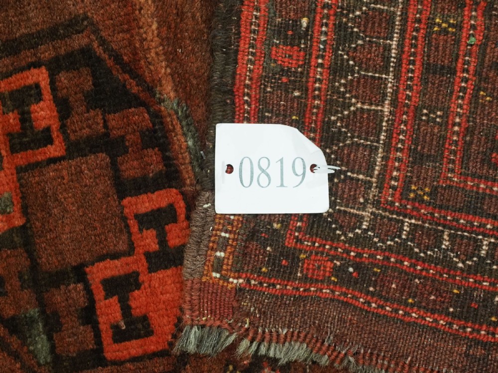 An antique Afghan Kizil Ayak Turkmen wool carpet featuring repeating octagonal gul motifs on a deep red field framed by geometric patterned borders. View XIV