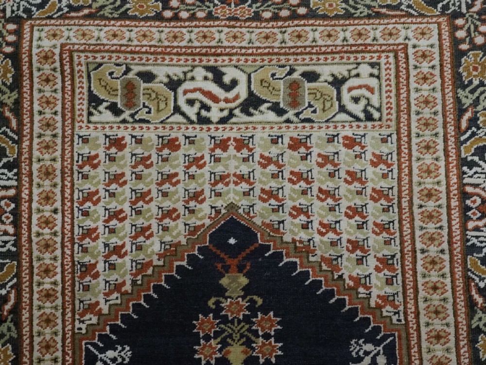An antique Turkish Panderma hand-knotted wool prayer rug featuring a navy central niche with a floral motif surrounded by detailed ivory and rust geometric floral borders. View IX