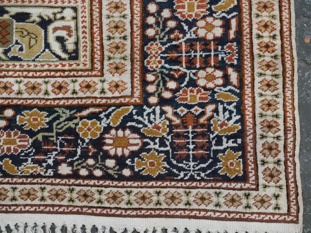 An antique Turkish Panderma hand-knotted wool prayer rug featuring a navy central niche with a floral motif surrounded by detailed ivory and rust geometric floral borders. View XIII