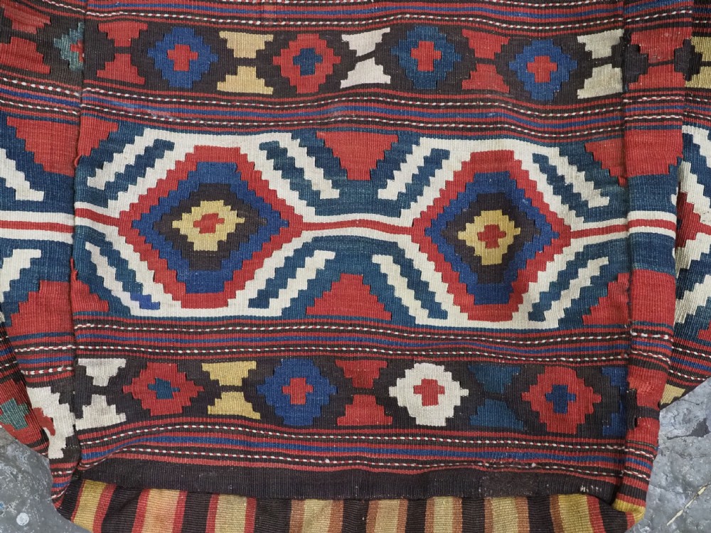 An antique hand-woven rectangular Caucasian mafrash storage bag decorated with red, blue, cream, and yellow geometric soumak patterns. View VI