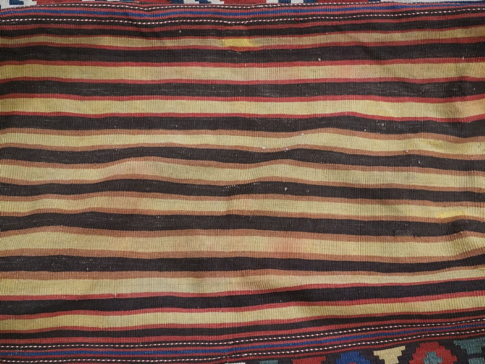 An antique hand-woven rectangular Caucasian mafrash storage bag decorated with red, blue, cream, and yellow geometric soumak patterns. View VIII