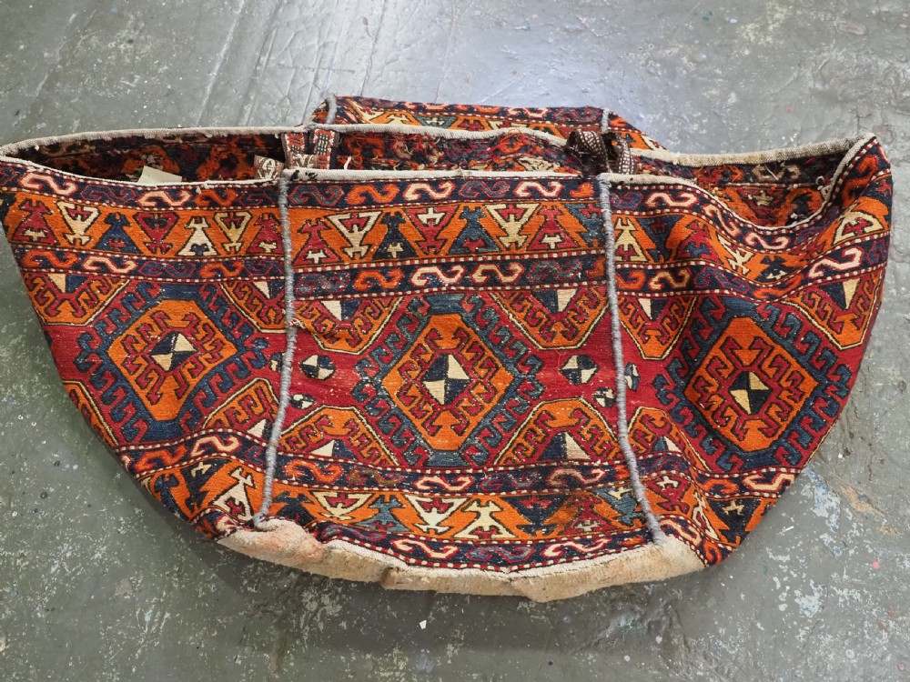 An antique South Caucasian mafrash storage bag featuring vibrant terracotta, navy blue, and cream geometric diamond patterns flat-woven in wool. View VII