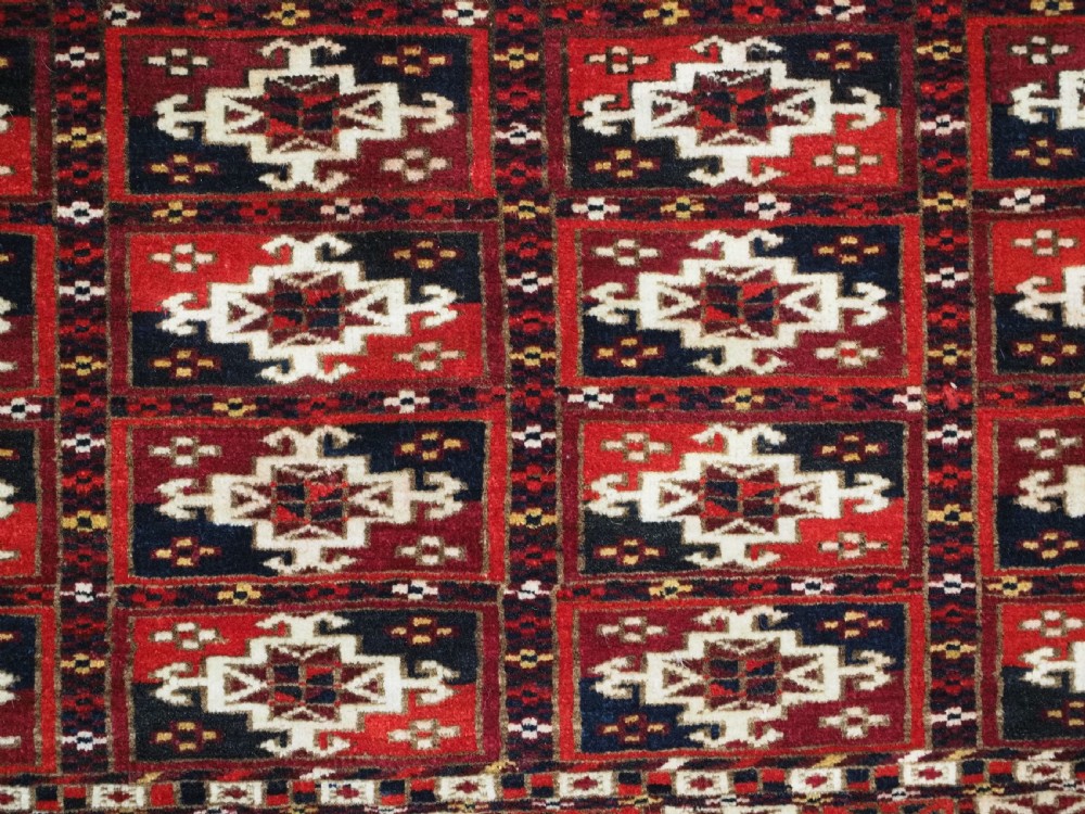 ANTIQUE TEKKE TURKMEN CHUVAL FACE OF SCARCE FORMAT WITH AINA GUL DESIGN, CIRCA 1880. View VII