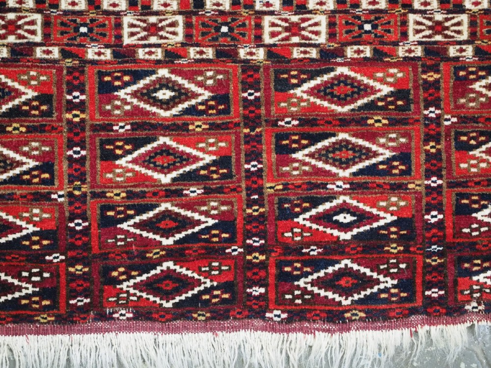 ANTIQUE TEKKE TURKMEN CHUVAL FACE OF SCARCE FORMAT WITH AINA GUL DESIGN, CIRCA 1880. View VIII
