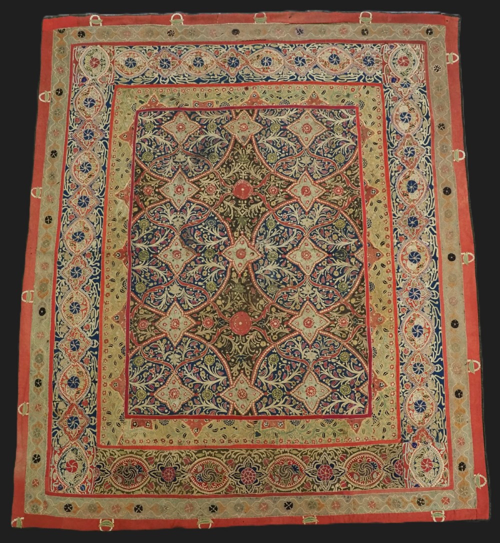 A rectangular 19th-century Persian Rasht textile featuring elaborate floral and geometric lattice patterns crafted from silk embroidery and felt applique in red, blue, green, and cream tones.