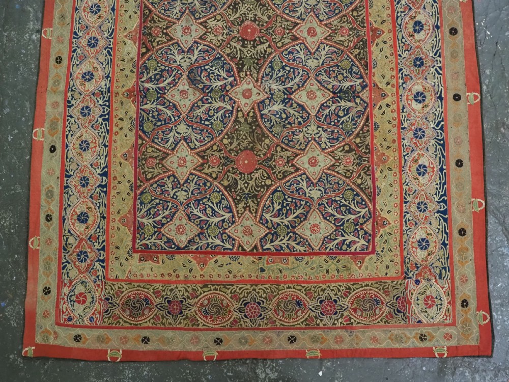 A rectangular 19th-century Persian Rasht textile featuring elaborate floral and geometric lattice patterns crafted from silk embroidery and felt applique in red, blue, green, and cream tones. View IV
