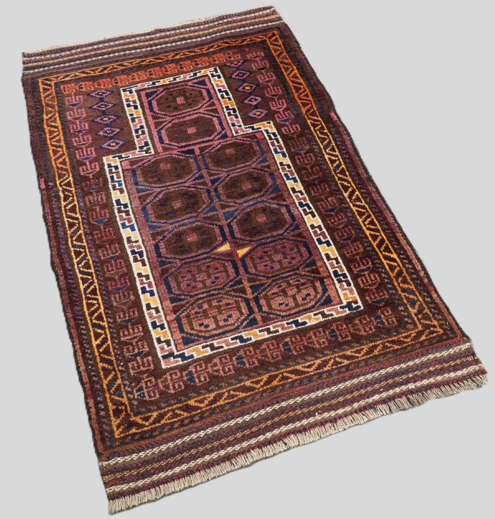 An antique hand-knotted Afghan Pashtun prayer rug featuring a dark brown background, stepped mihrab niche, geometric motifs in magenta and navy, and flat-woven kilim ends. View II