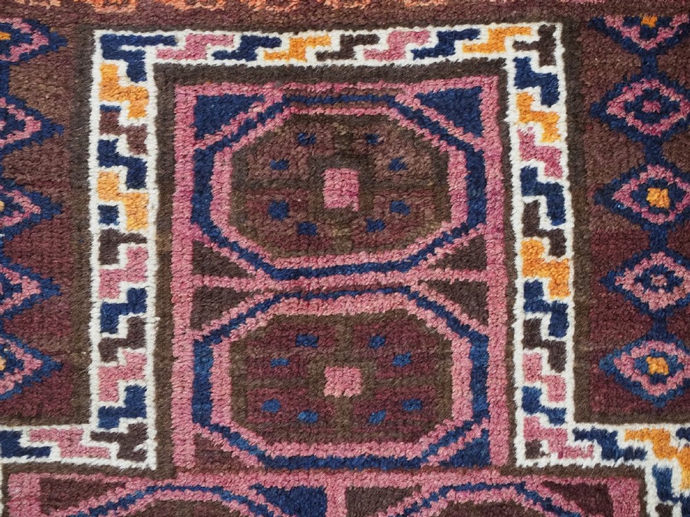 An antique hand-knotted Afghan Pashtun prayer rug featuring a dark brown background, stepped mihrab niche, geometric motifs in magenta and navy, and flat-woven kilim ends. View VIII
