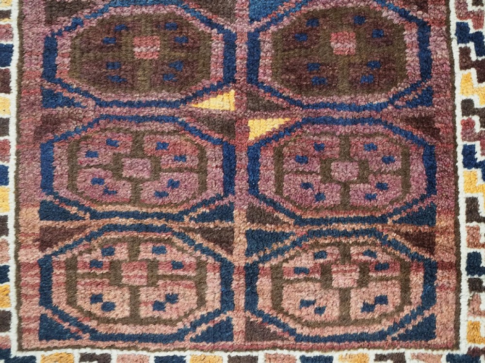 An antique hand-knotted Afghan Pashtun prayer rug featuring a dark brown background, stepped mihrab niche, geometric motifs in magenta and navy, and flat-woven kilim ends. View IX