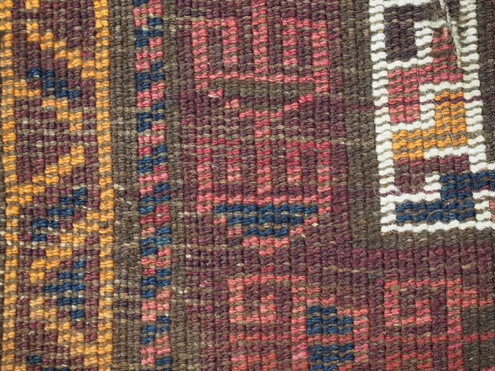 An antique hand-knotted Afghan Pashtun prayer rug featuring a dark brown background, stepped mihrab niche, geometric motifs in magenta and navy, and flat-woven kilim ends. View XI