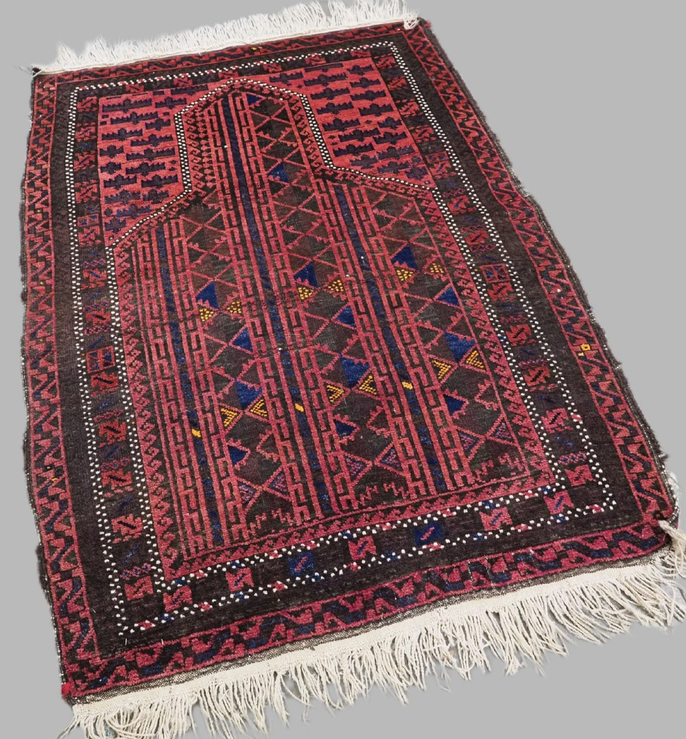 An antique Afghan wool prayer rug displaying a dark brown field with geometric lattice patterns framed by a terracotta arch motif. View II