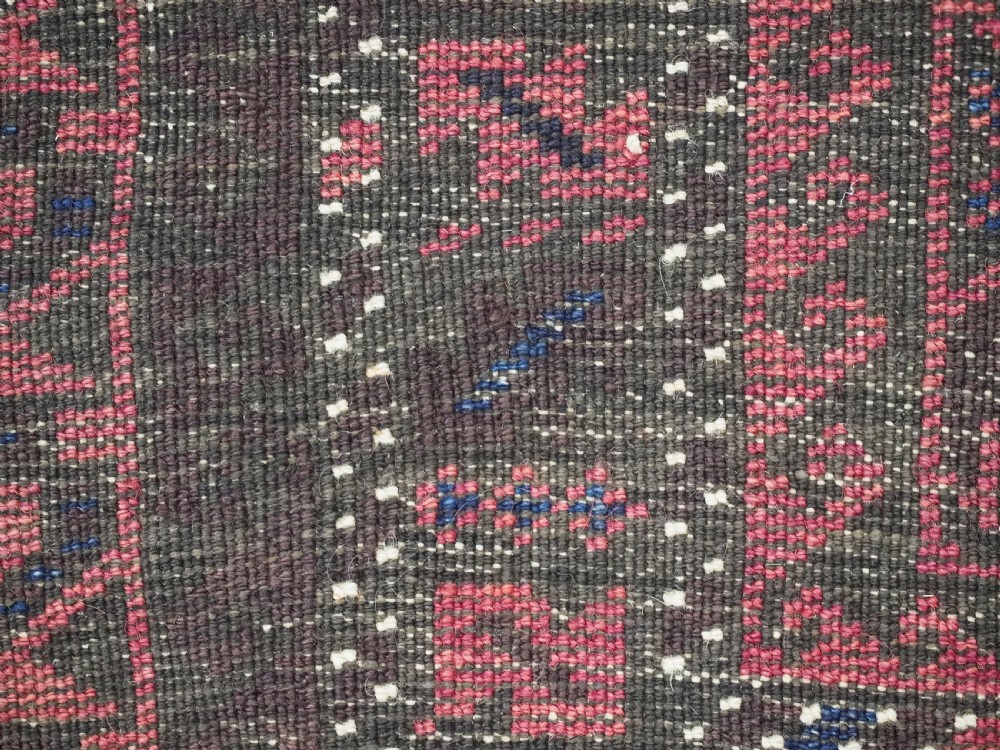 An antique Afghan wool prayer rug displaying a dark brown field with geometric lattice patterns framed by a terracotta arch motif. View XI