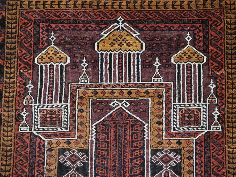 An antique hand-knotted Afghan Baluch wool prayer rug featuring a triple mihrab architectural design in burgundy, brown, ochre, and white tones. View VIII