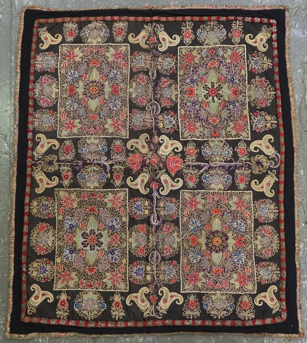 An antique Persian Rasht textile featuring silk floral and boteh embroidery on a black wool felt ground.