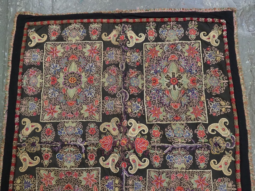 An antique Persian Rasht textile featuring silk floral and boteh embroidery on a black wool felt ground. View IV