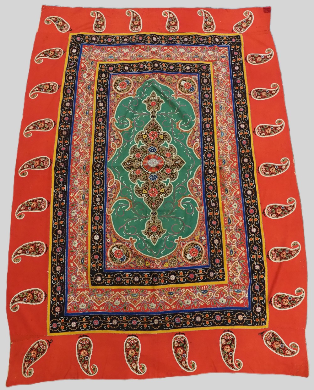 A rectangular antique Persian Rasht embroidery featuring a bright red outer border with boteh motifs surrounding a central green medallion with detailed silk stitching.