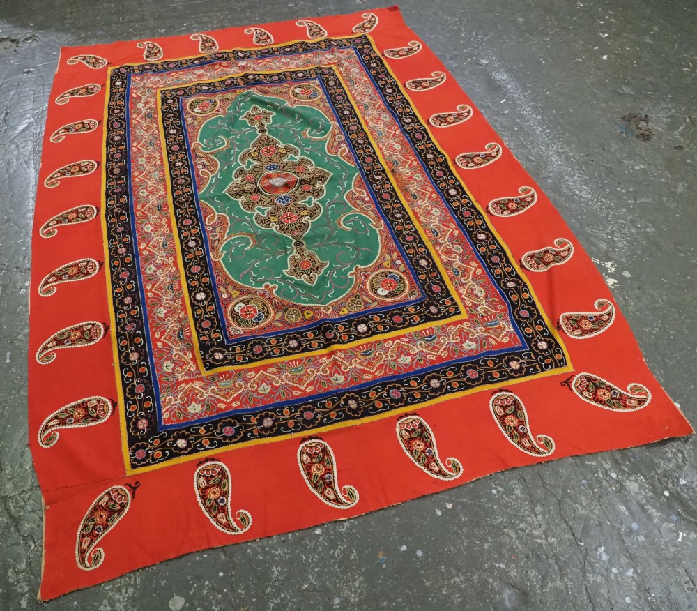 A rectangular antique Persian Rasht embroidery featuring a bright red outer border with boteh motifs surrounding a central green medallion with detailed silk stitching. View IV