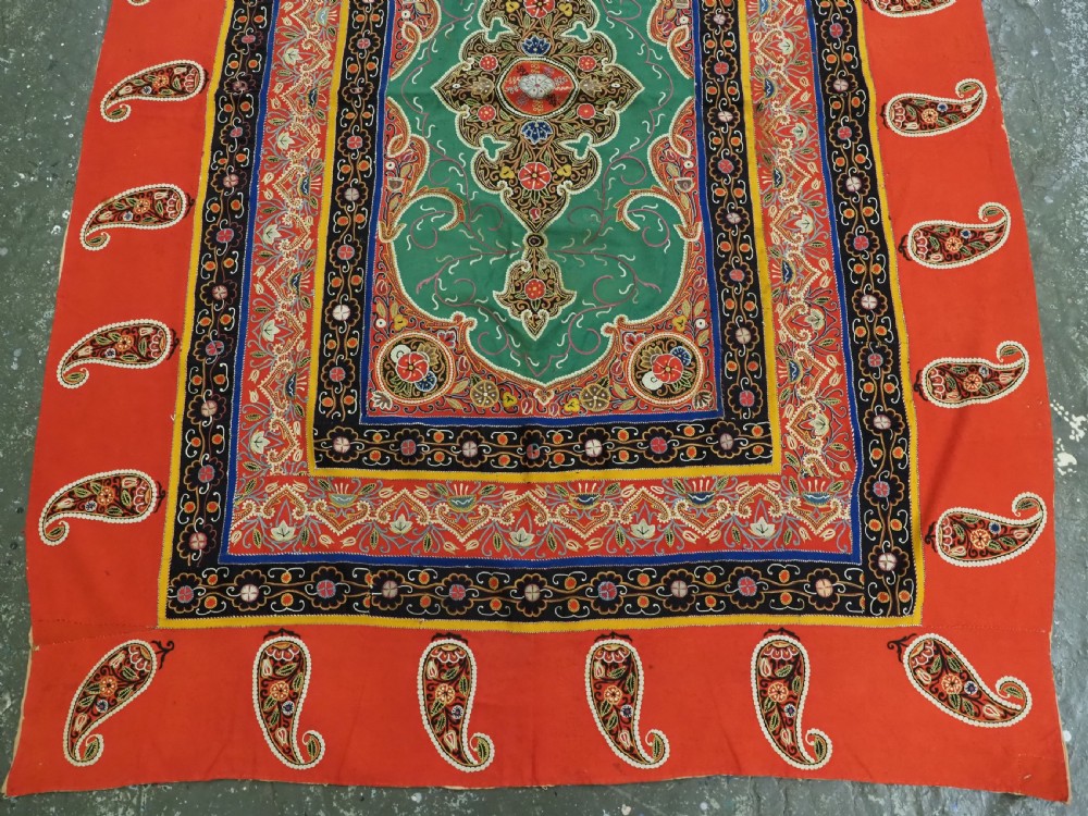 A rectangular antique Persian Rasht embroidery featuring a bright red outer border with boteh motifs surrounding a central green medallion with detailed silk stitching. View VI