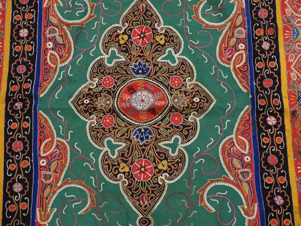A rectangular antique Persian Rasht embroidery featuring a bright red outer border with boteh motifs surrounding a central green medallion with detailed silk stitching. View XII