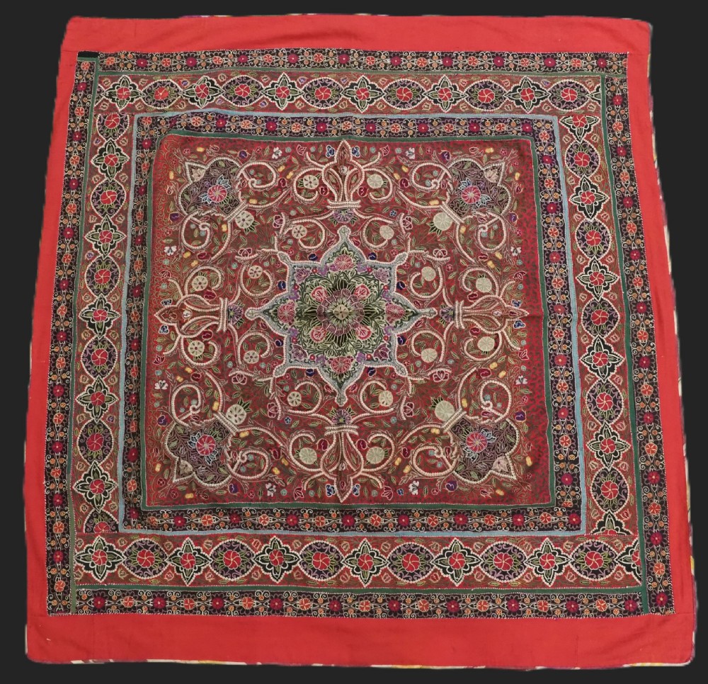 Square antique Persian Rasht embroidery featuring a central green and pink star medallion surrounded by floral motifs on red wool felt with decorative patterned borders. View II