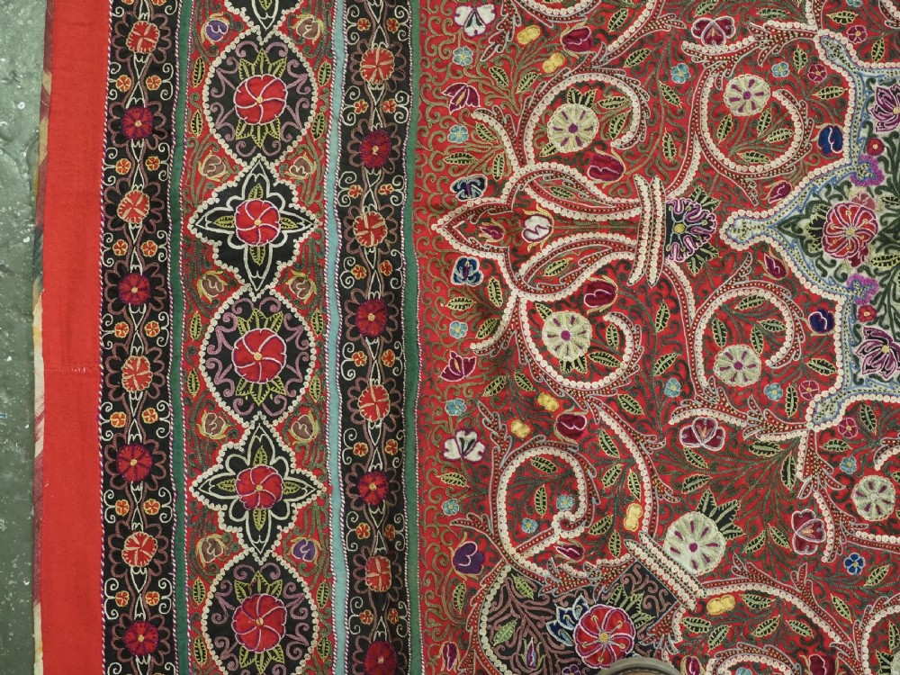 Square antique Persian Rasht embroidery featuring a central green and pink star medallion surrounded by floral motifs on red wool felt with decorative patterned borders. View VIII
