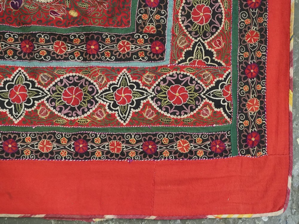 Square antique Persian Rasht embroidery featuring a central green and pink star medallion surrounded by floral motifs on red wool felt with decorative patterned borders. View XIII