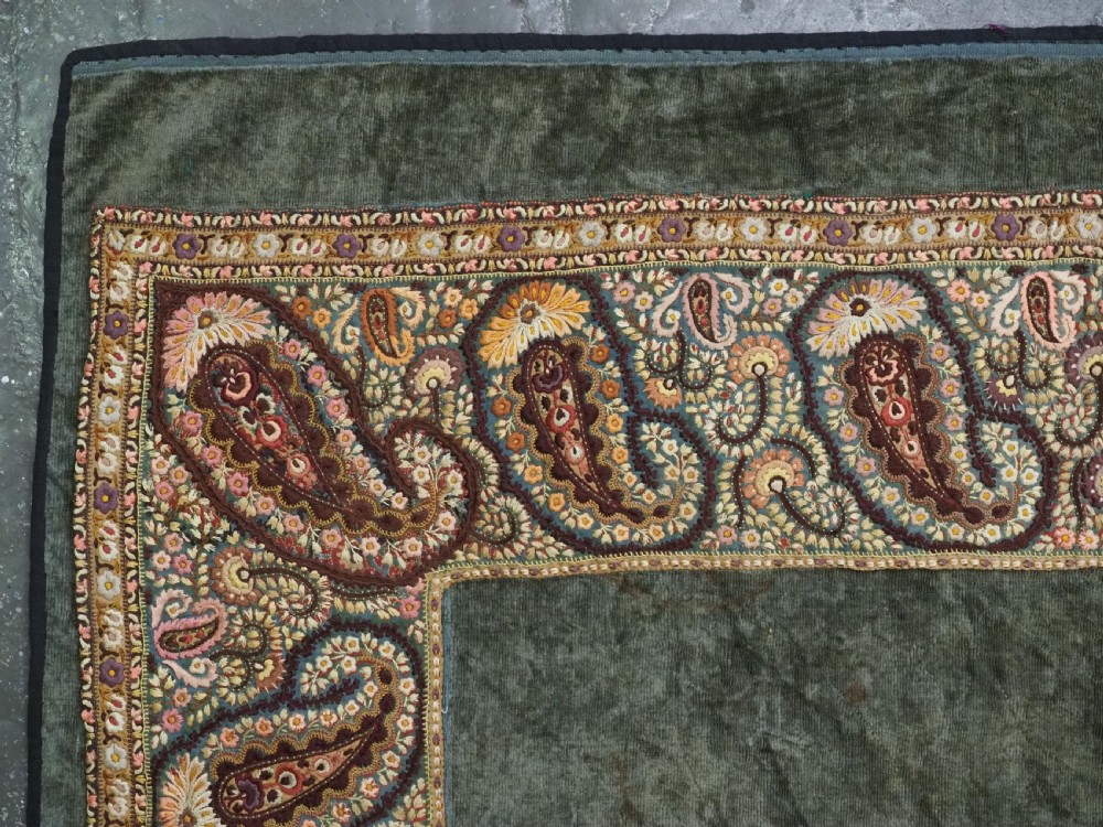 An antique rectangular olive green velvet textile decorated with intricate silk paisley embroidered borders and a fringed edge. View IV