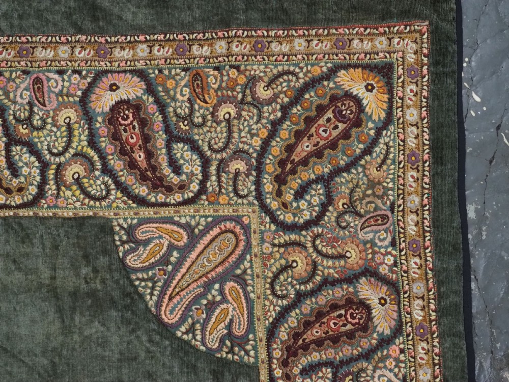 An antique rectangular olive green velvet textile decorated with intricate silk paisley embroidered borders and a fringed edge. View VIII