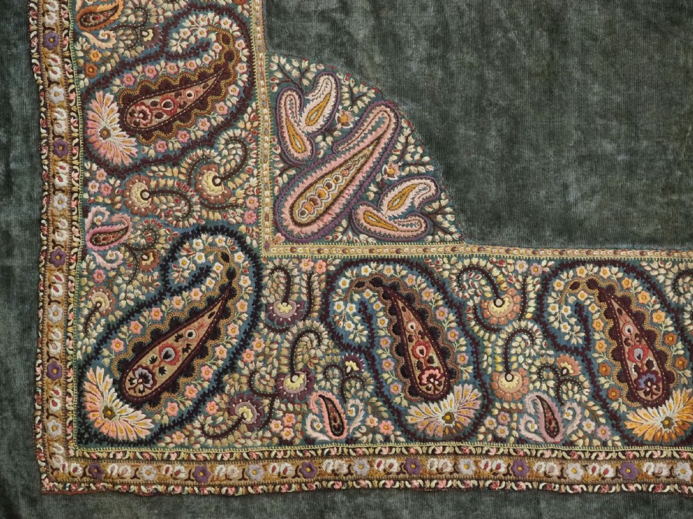An antique rectangular olive green velvet textile decorated with intricate silk paisley embroidered borders and a fringed edge. View IX