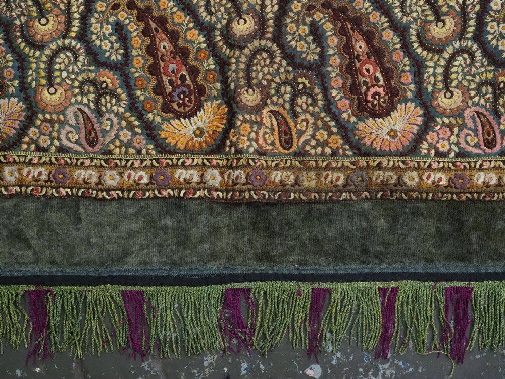 An antique rectangular olive green velvet textile decorated with intricate silk paisley embroidered borders and a fringed edge. View XII