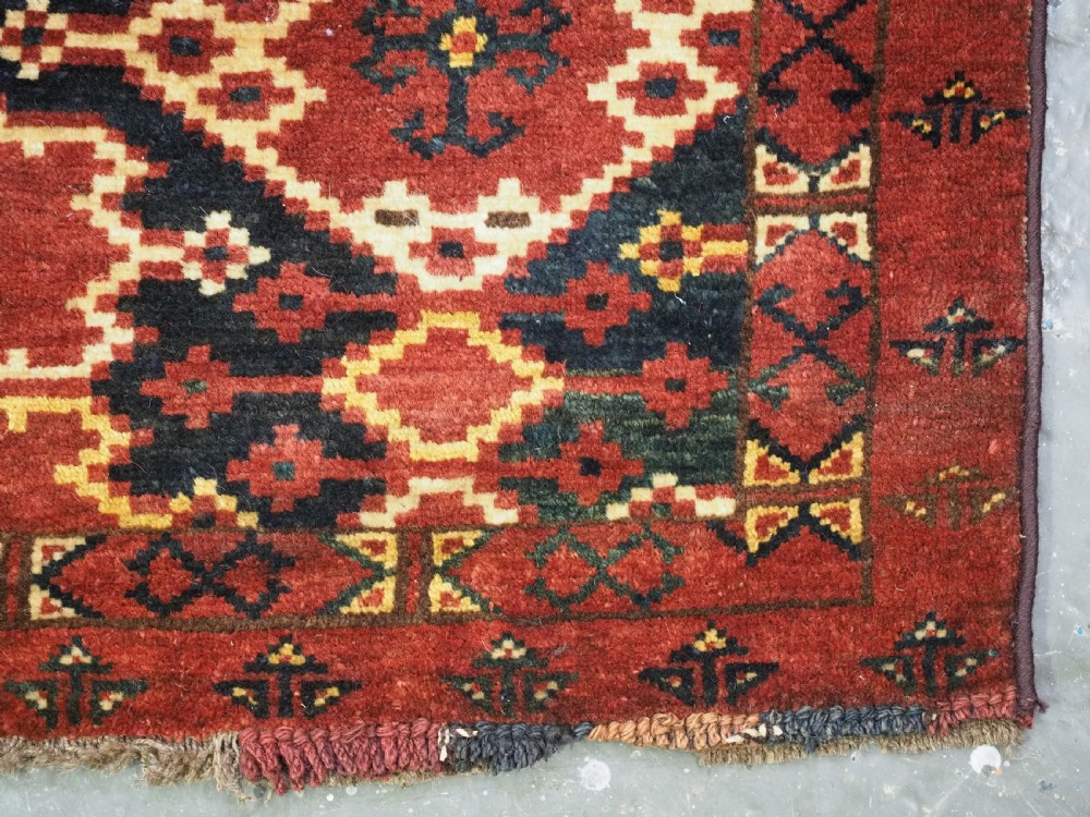 A horizontal rectangular antique Ersari Beshir Turkmen torba textile woven in deep red wool with geometric ikat diamond patterns. View XIV