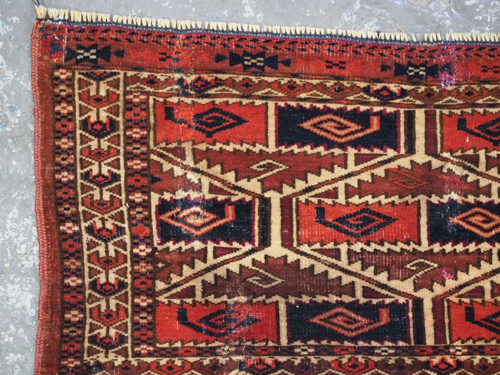 A rectangular hand-woven Tekke Turkmen torba panel featuring deep red, navy blue, and ivory geometric patterns with lower wool fringing. View V