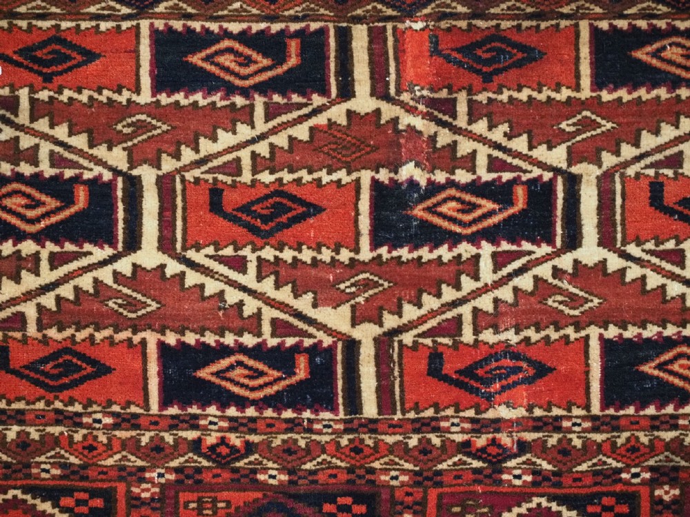 A rectangular hand-woven Tekke Turkmen torba panel featuring deep red, navy blue, and ivory geometric patterns with lower wool fringing. View VII