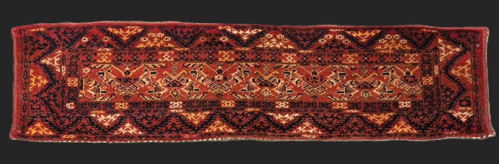 A long horizontal antique Ersari Turkmen wool woven bag face featuring intricate geometric tribal patterns in dark red, navy blue, yellow, and cream tones.