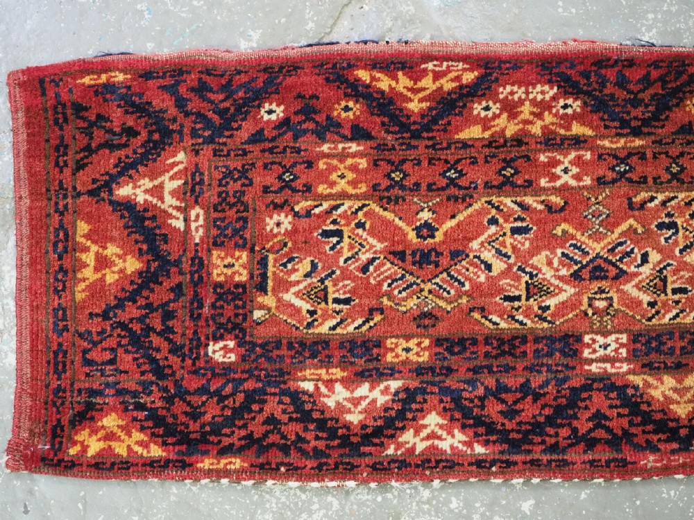 A long horizontal antique Ersari Turkmen wool woven bag face featuring intricate geometric tribal patterns in dark red, navy blue, yellow, and cream tones. View II