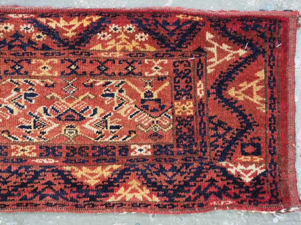 A long horizontal antique Ersari Turkmen wool woven bag face featuring intricate geometric tribal patterns in dark red, navy blue, yellow, and cream tones. View V
