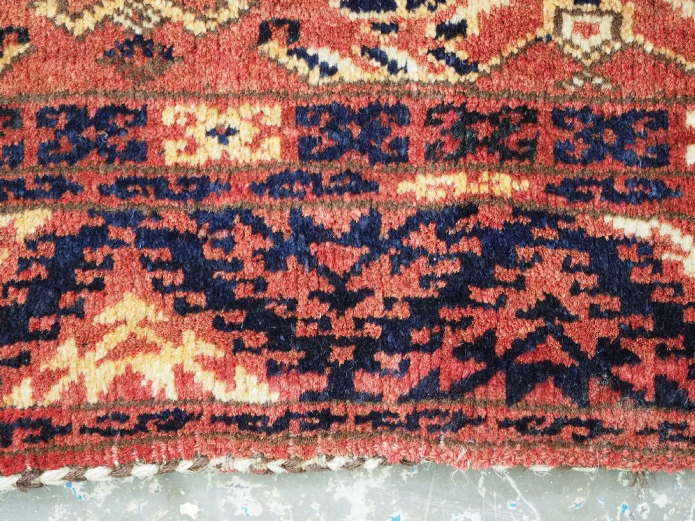 A long horizontal antique Ersari Turkmen wool woven bag face featuring intricate geometric tribal patterns in dark red, navy blue, yellow, and cream tones. View VII