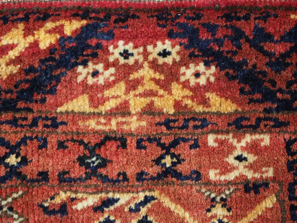 A long horizontal antique Ersari Turkmen wool woven bag face featuring intricate geometric tribal patterns in dark red, navy blue, yellow, and cream tones. View VIII