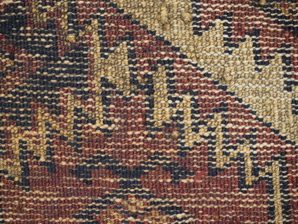 An antique rectangular Ersari Turkmen torba bag face featuring geometric curled leaf motifs in navy blue and terracotta red on an ivory background with fringed trim. View XII