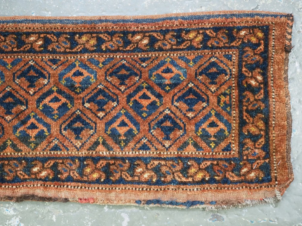 A horizontal antique Ersari Turkmen hand-knotted wool torba face featuring repeated geometric schemle gul motifs in dark blue and terracotta red tones. View V