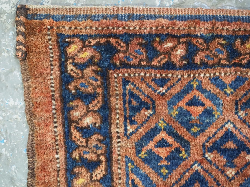 A horizontal antique Ersari Turkmen hand-knotted wool torba face featuring repeated geometric schemle gul motifs in dark blue and terracotta red tones. View VI