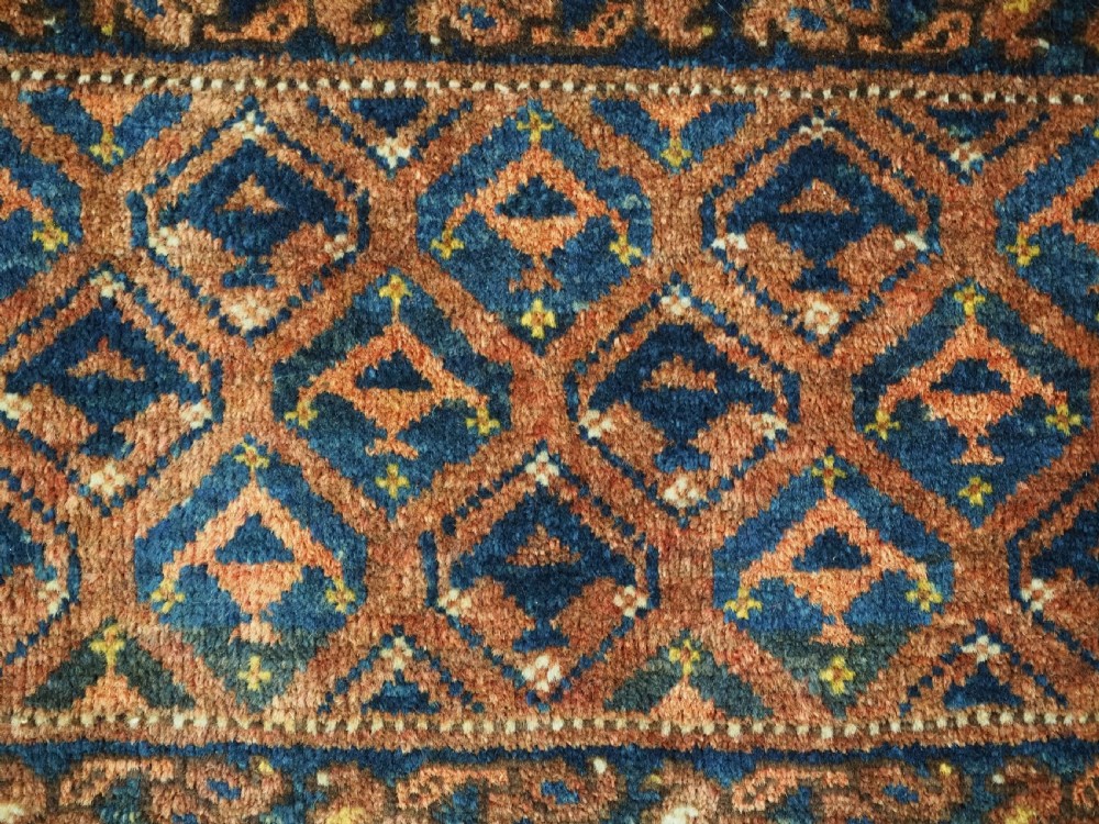 A horizontal antique Ersari Turkmen hand-knotted wool torba face featuring repeated geometric schemle gul motifs in dark blue and terracotta red tones. View VIII